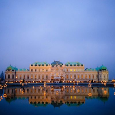 Picture of beautiful castle in Vienna which is reflected in the water at dusk