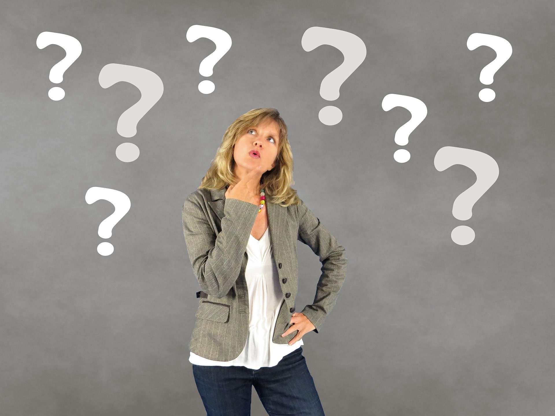 Gigolo booking - woman looking at question marks against gray background